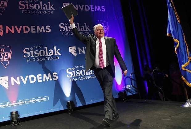 Nevada Gov.-elect Steve Sisolak takes the stage at a Democratic election night party Wednesday, Nov. 7, 2018, in Las Vegas. (AP Photo/John Locher)