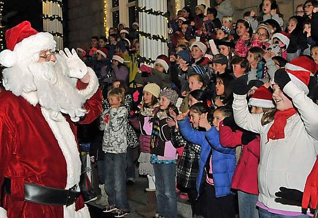 Santa leads the children in song as they perform on the Capitol steps during a past Silver &amp; Snowflakes Festival of Lights.