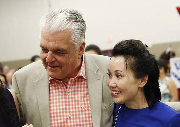 File - In this Aug. 28, 2018 file photo, Clark County Commission member and Democratic gubernatorial candidate Steve Sisolak and Kathy Ong meet others at an event in Las Vegas. Nevada Governor-elect Steve Sisolak is now engaged to be married. The Democrat&#039;s campaign on Monday, Nov. 12, 2018, announced the engagement to his girlfriend of more than five years, Kathy Ong. Ong is a financial consultant in Las Vegas. Sisolak and Ong met at their local gym. Details of the wedding were not released. (AP Photo/John Locher)