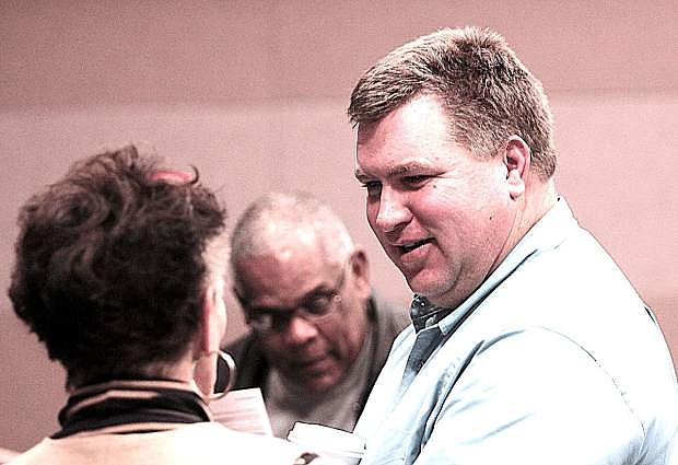 Sheriff-elect Richard Hickox, right, talks to supporters while waiting for election results.