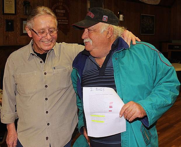 Lance McNeil, left, gives volunteer and retired Army paratrooper Roy Miller a list for deliveries.