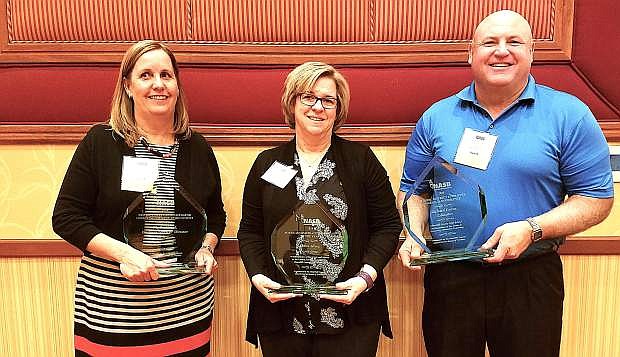 From left are Debra Shyne, School Board Administrative Assistant of the Year; Phyllis Dowd, District Level Administrator Impacting Student Achievement award; and Richard Evans, School District Employee Making a Difference award.