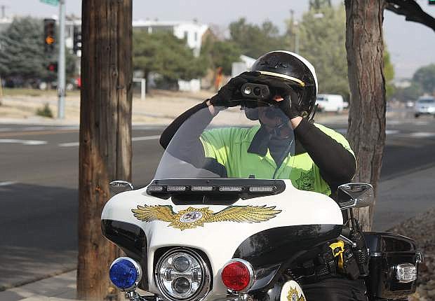 Carson City Sheriff&#039;s Deputy Joey Trotter monitors speed with a Lidar tool on Roop Street. The Carson City Board of Supervisors voted to reinstate a traffic enforcement program.