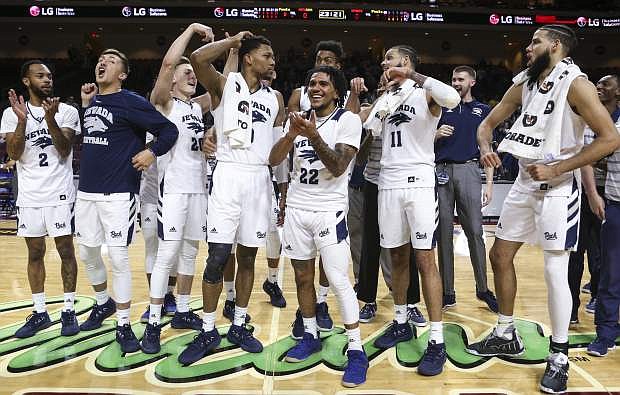 Nevada players celebrate their win over Massachusetts in an NCAA college basketball game Friday, Nov. 23, 2018, in Las Vegas. (AP Photo/Chase Stevens)