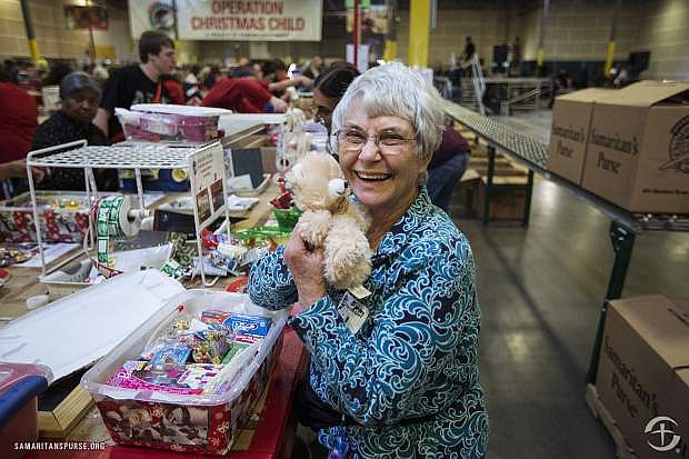A volunteer helps to pack shoeboxes at a Samaritan&#039;s Purse distribution center.