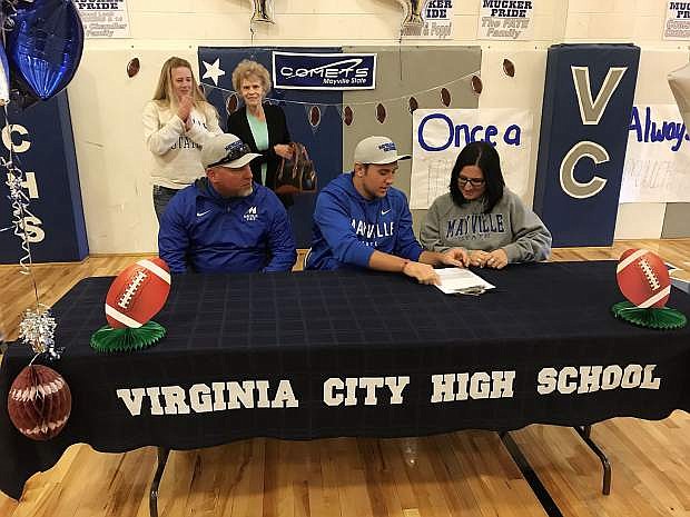 Tabor Fletcher signs his letter of intent. Sitting with him are his father Tad Fletcher and mother T.J. Fletcher. In back are his stepmother Wendy Fletcher and grandmother Bev Fletcher.