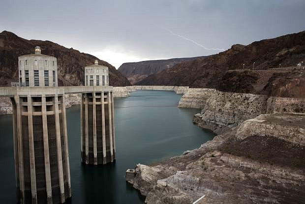 FILE - In this July 28, 2014, file photo, lightning strikes over Lake Mead near Hoover Dam that impounds Colorado River water at the Lake Mead National Recreation Area in Arizona. With drought continuing and reservoirs shrinking, several Southwestern U.S. states that depend on the Colorado River had been expected to ink a crucial share-the-pain contingency plan by the end of 2018. Officials now say they&#039;re not going to make it, at least not in time for upcoming meetings in Las Vegas involving representatives from Arizona, California, Colorado, Nevada, New Mexico, Utah, Wyoming and the U.S. government. (AP Photo/John Locher, File)