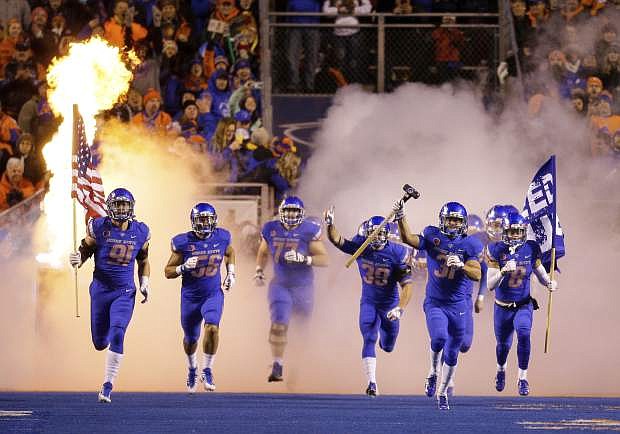 Boise State runs on to the field beforeits game with Utah State on Saturday in Boise, Idaho. Boise State won 33-24.