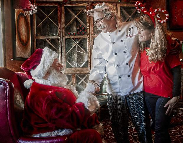 Santa Strekal greets Chef Charlie and Karen Abowd. Santa will appear at the annual Cookies with Santa event Saturday at Cafe at Adele&#039;s at 1112 N. Carson St. in Carson City.