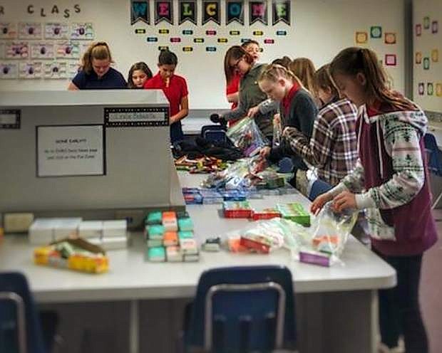 Students from Eagle Valley Middle School prepare kits for the homeless at their SOAR Club meeting hosted during their lunch break Thursday.