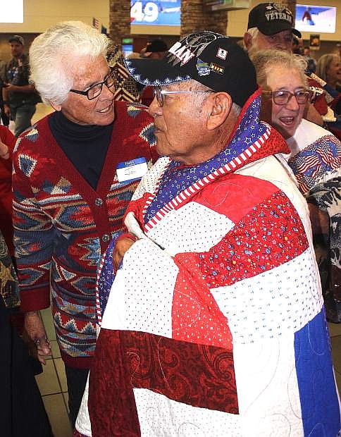 Reynold Sammaripa of Schurz wears a hand-sewn quilt at the Reno-Tahoe International Airport.