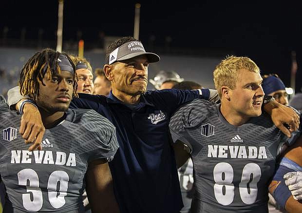 Nevada head coach Jay Norvell celebrates with his team after beating San Diego State 28-24 in a NCAA college football game in Reno, Nev., Saturday, Oct. 27, 2018. (AP Photo/Tom R. Smedes)
