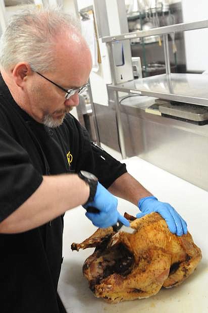 Assistant Executive Chef Scott Brown carves a turkey into serving pieces. Unlike most home cooks, it takes him just about one minute to dismember the bird. He will do same to well over 100 turkeys the Nugget will serve to people on Thanksgiving Day.