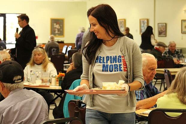 GNC volunteers help in the senior center dining room.