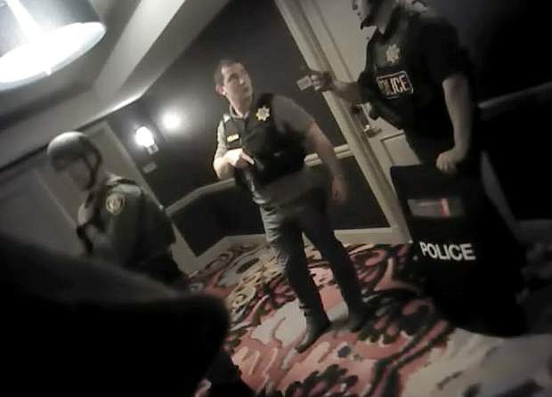 FILE - In this Oct. 1, 2017, file image from police body cam video released by the Las Vegas Metropolitan Police Department on July 25, 2018, shows law enforcement officers in a hallway at the Mandalay Bay Resort and Casino while searching for a shooter in Las Vegas. Police in Las Vegas said Thursday, Jan. 3, 2019, they have finished releasing audio, video and written records about the investigation of the deadliest mass shooting in modern U.S. history. (Las Vegas Metropolitan Police Department via AP, File)