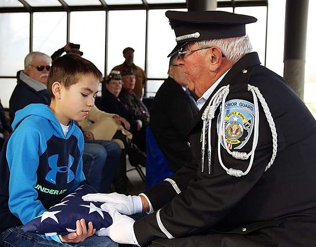 Johnny Paul, 11, of Sparks, receives the United States flag from Nevada Veterans Coalition member Jerry Finley.