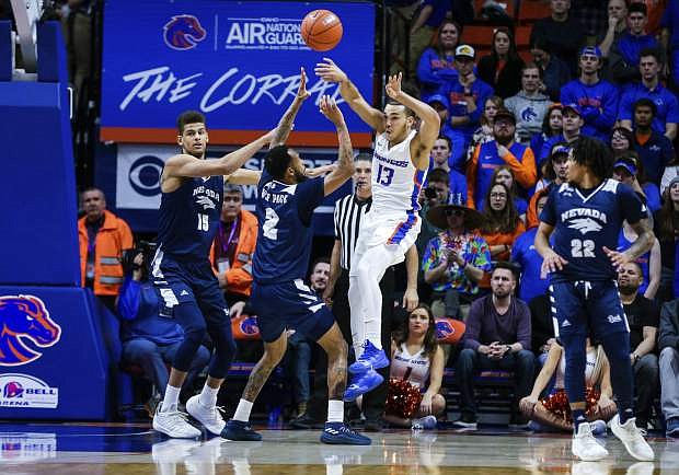 Boise State guard Pat Dembley (13) throws the ball against a Nevada double team during the first half of an NCAA college basketball game, Tuesday, Jan. 15, 2019, in Boise, Idaho. (AP Photo/Steve Conner)