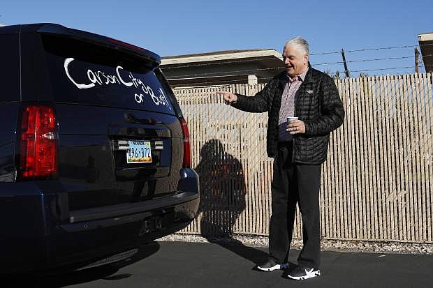 Nevada Governor-elect Steve Sisolak reacts to a message written on his vehicle after visiting an International Alliance of Theatrical Stage Employees union hall Friday, Jan. 4, 2019, in Las Vegas. The visit was one stop on a road trip through Nevada before his inauguration Monday in Carson City, Nev. (AP Photo/John Locher)