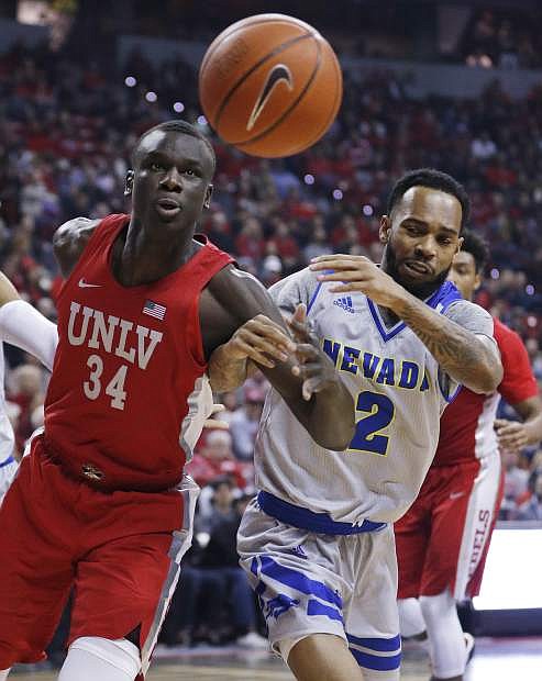 UNLV&#039;s Cheikh Mbacke Diong, left, and Nevada&#039;s Corey Henson watch the ball while going for a rebound during the first half of an NCAA college basketball game Tuesday, Jan. 29, 2019, in Las Vegas. (AP Photo/John Locher)