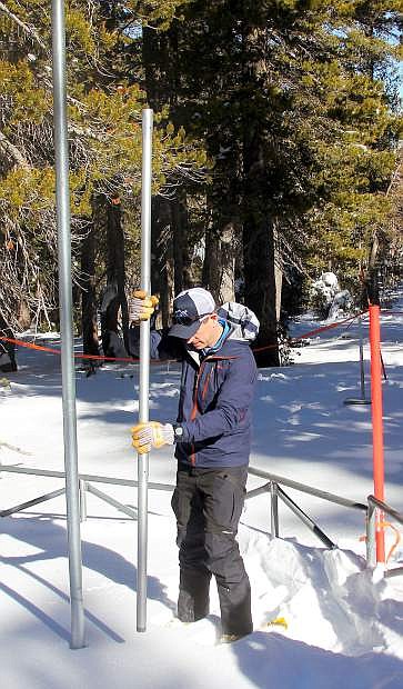 Natural Resources Conservation Service hydrologist Jeff Anderson measures the snowpack Wednesday at Mt. Rose Ski Tahoe.