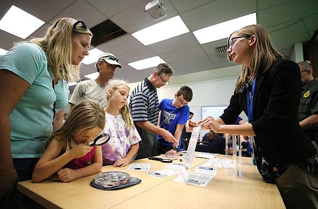 Creative Learning Manager Maria Klesta, right, talks with Shannon Schnaible and her daughters Amelia, 6, and Cadence, 8, during the NASA@ My Library event at the Carson City Library, in August 2018. The library invites the community to participate in workshops and a survey as part of their process to create a new strategic plan. Photo by Cathleen Allison/Nevada Momentum