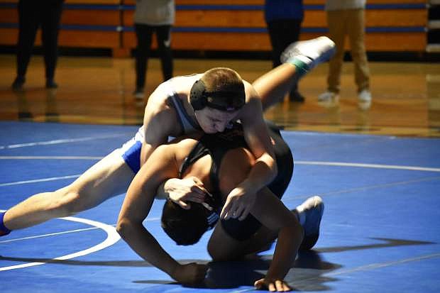 Cole Ashton on his way to winning by pin to secure the league title last week against Douglas.