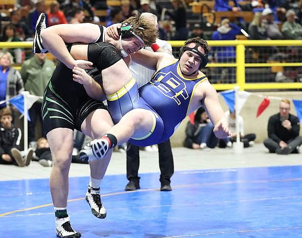 Fallon senior Ben Dooley trips up Boulder City&#039;s Mike Kaposta in the first period of his quarterfinal match on Friday at the Winnemucca Events Center.