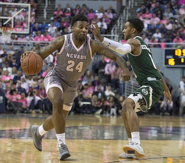 Nevada forward Jordan Caroline (24) drives past Colorado State guard Hyron Edwards (0) during the first half of an NCAA college basketball game in Reno, Nev., Wednesday, Jan. 23, 2019. (AP Photo/Tom R. Smedes)