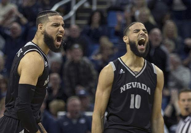 Nevada forwards Caleb (10) and Cody Martin react after a big basket against New Mexico in the first half Saturday in Reno.