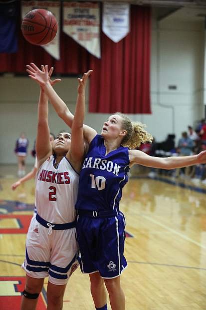 Abby Pradere battles for the basketball at Reno High on Wednesday.