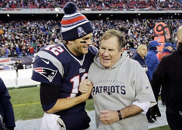 FILE - In this Dec. 14, 2014, file photo, New England Patriots quarterback Tom Brady, left, celebrates with head coach Bill Belichick after defeating the Miami Dolphins 41-13 in an NFL football game in Foxborough, Mass.