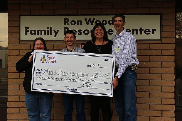 From left, Tracy Thompson, store manager of Save Mart #551 at 4348 S. Carson St., Daniel McKnight, Save Mart assistant store manager, Joyce Buckingham, executive director of the Ron Wood Family Resource Center, and Chris Benson, store manager of Save Mart #552, gather for Save Mart&#039;s check donation to the Ron Wood Center Friday.