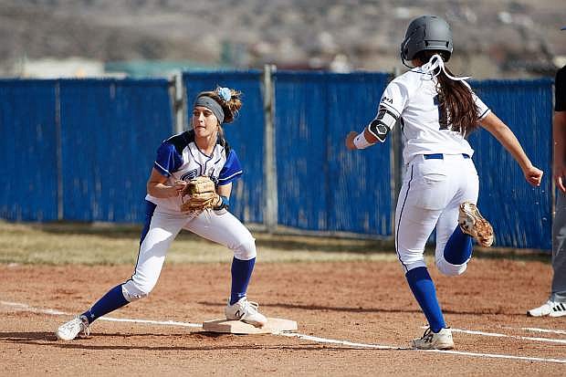 Carson High&#039;s Kailee Luschar covers first base for an out during the game against McQueen High on Thursday.