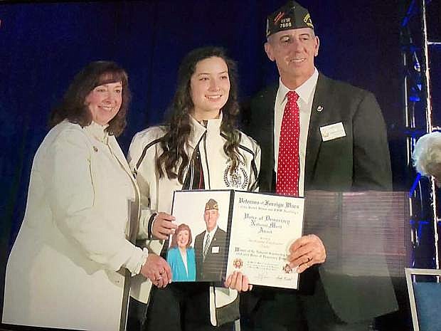VFW National Commander B.J. Lawrence, right, and VFW Auxiliary President Sandi Kriebel present Voice of Democracy seventh-place winner Ashby Trotter (center) with her award.