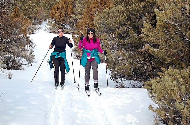 Jenny Wilson, left, and Tiffany Swetich traverse the 4.1-mile Bristlecone Birkebeiner Cross Country Ski Race course on Jan. 19, 2019. The course entails a loop through pinyon and juniper tree groves within the Ward Mountain Recreation Area near Ely, Nevada. Photo by Erick Studenicka/Nevada Momentum