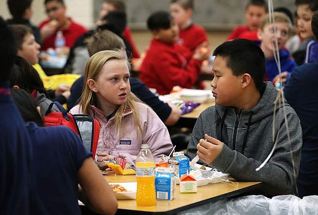 Members of the Eagle Valley Middle School Students Offering Additional Resources club host &quot;No One Eats Alone Day&quot; at the school in Carson City, Nev., on Thursday, March 7, 2019. Jocelyn Pedersen invited Jason Jia, both 12, to join her lunch group. Jia, who recently moved to Carson City from China, said he often eats lunch alone. Photo by Cathleen Allison/Nevada Momentum
