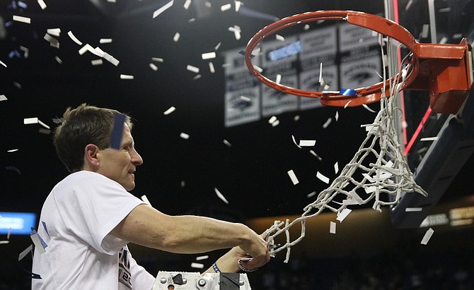  Wolf Pack coach Eric Musselman is the last person to cut the net after Nevada won a piece of the Mountain West Conference championship against San Diego State Saturday night.