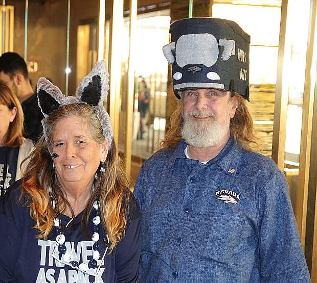 Wolf Pack fans Kris and Bear Updike wear their good luck hats at a sendoff for the Nevada men&#039;s basketball team on Friday.