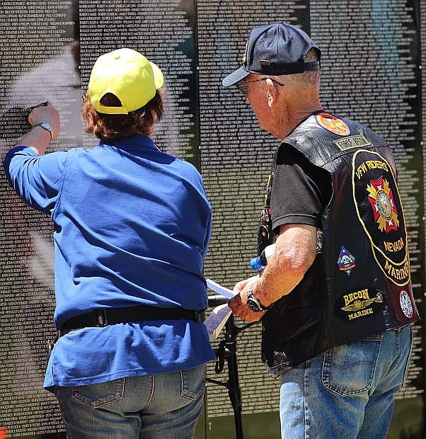 A couple looks for a name on the Vietnam Moving Wall, which was on display in Minden last year.