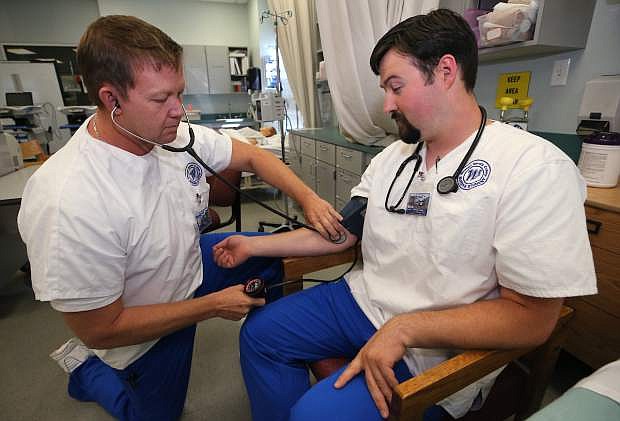 Joseph Yearn and Quentin Knowles work in a nursing class at Western Nevada College in Carson City.