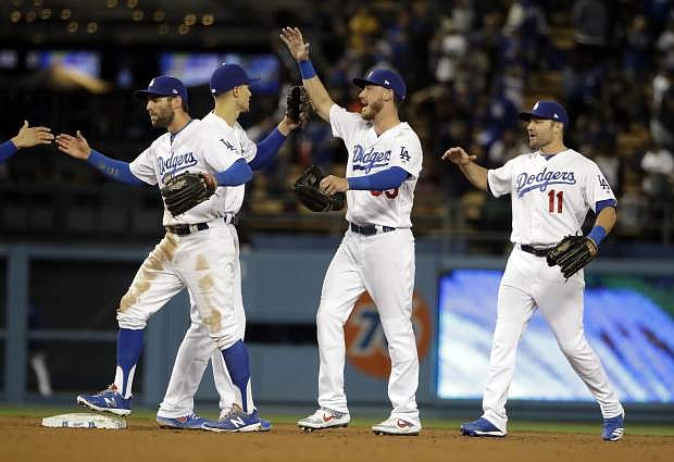 The Los Angeles Dodgers celebrate after a 6-5 win over the San Francisco Giants during a baseball game, Tuesday, April 2, 2019, in Los Angeles. (AP Photo/Marcio Jose Sanchez)