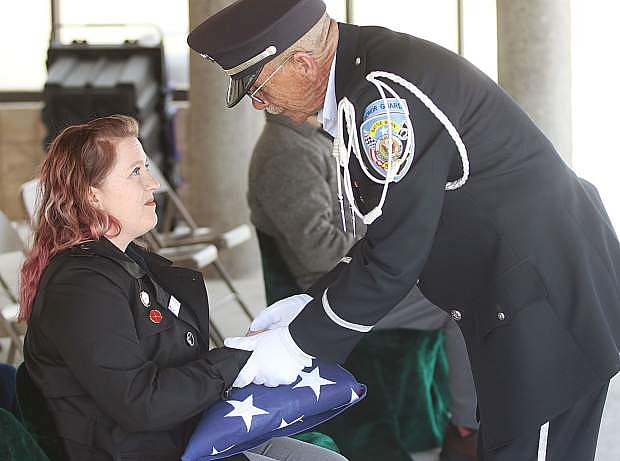 Brett Palmer, right, of the Nevada Veterans Coalition talks to Courtenay Burns after she accepts the flag after the March military service at the Northern Nevada Veterans Memorial Cemetery in Fernley.