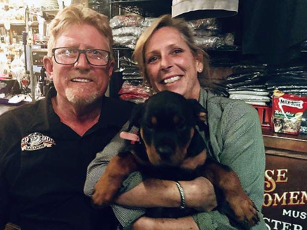 Loren and Sue Pursel pose with Rosie the Red Dog, the new mascot of the Red Dog Saloon. This year marks 10 years the couple has owned the iconic bar.
