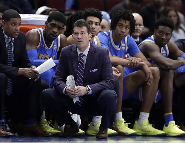 This Dec. 22, 2018, file photo shows UCLA head coach Steve Alford and his players watching during the second half against Ohio State.