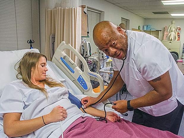 Kendell Oliver, left and Clifton Bullock work in a Certified Nursing Assistant class at the Fallon campus of Western Nevada College in Fallon, on Monday, October 9, 2017.