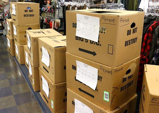 Stacks of boxes containing donations of new pairs of shoes wait to be delivered to Carson City schools on Wednesday at Big 5 Sporting Goods&#039; South Carson Street location.