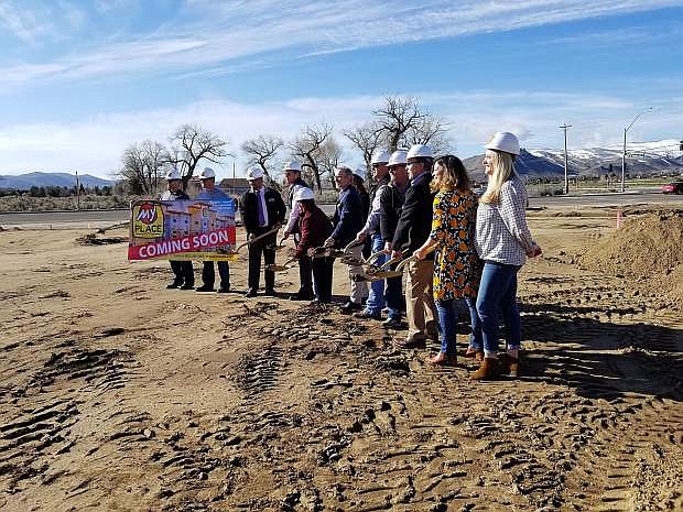 Supervisor Lori Bagwell, Mayor Bob Crowell, City Manager Nancy Paulson, Jason Welk, My Place Hotels co-owner, and others throw dirt at the site of the future Carson City My Place Hotel.