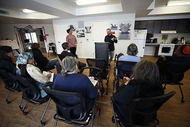 Hannah McDonald, director of Partnership Carson City, left, and Drake  Dembke, with Life Change Center, make a presentation about Naloxone and safe disposal of unused drugs at Richards Crossing, in Carson City, Nev., on Thursday, April 11, 2019.