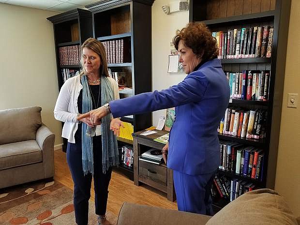 Sen. Jacky Rosen, right, speaks with Heather Simola, Nevada Rural Housing Authority, in the library of Richards Crossing.