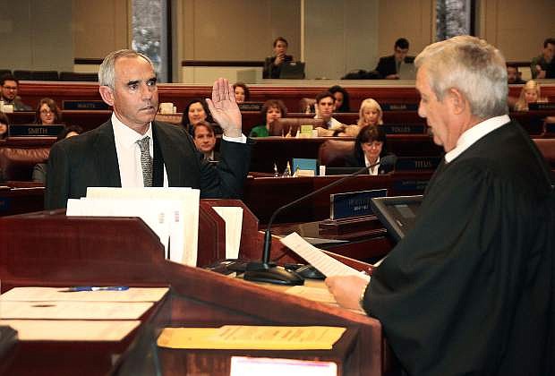 Nevada Assemblyman Greg Smith, D-Sparks, is sworn in to office by Nevada Supreme Court Justice James Hardesty at the Legislative Building in Carson City, Nev., on Wednesday, March 27, 2019. Smith was appointed to the vacant seat by Washoe County Commissioners after Assemblyman Mike Sprinkle resigned earlier this month following sexual harassment claims. Photo by Jim Grant/Nevada Momentum